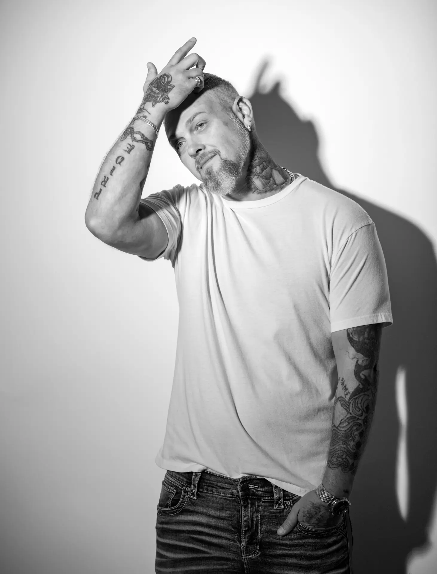 Portrait of a man in a white t-shirt against a warm backdrop